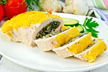 Image showing Roll chicken with spinach and cucumber on board