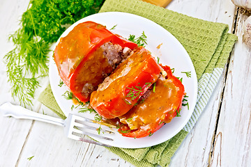 Image showing Pepper stuffed meat with sauce in plate on table