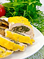 Image showing Roll chicken with champignons and spinach on board