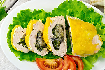 Image showing Roll chicken with spinach and lettuce on board