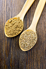 Image showing Flour and seed of hemp in wooden spoon on board