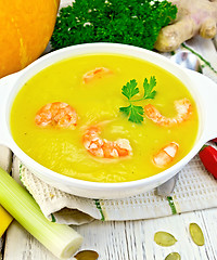 Image showing Soup-puree pumpkin with shrimp in white bowl on light board