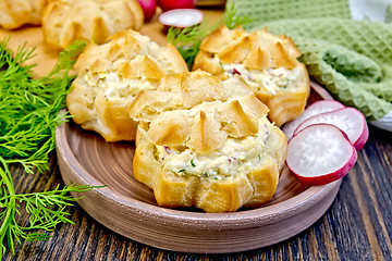 Image showing Appetizer of radish and cheese in profiteroles on clay plate