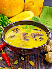 Image showing Soup-puree pumpkin with mushrooms on dark board