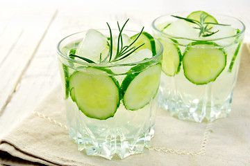 Image showing Lemonade with cucumber and rosemary in two glassful on napkin