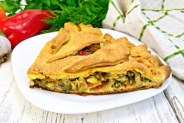 Image showing Pie with cabbage and sorrel in plate on board