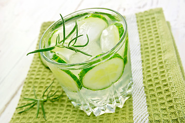 Image showing Lemonade with cucumber and rosemary in glassful on board