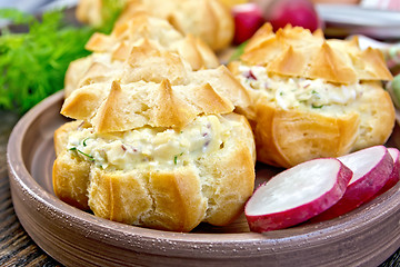 Image showing Appetizer of radish and cheese in profiteroles on plate with dil