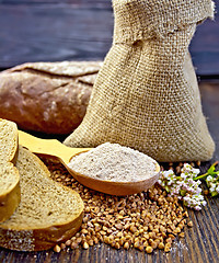 Image showing Flour buckwheat in spoon with grains on board