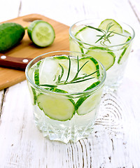 Image showing Lemonade with cucumber and rosemary in two glassful on white boa