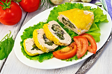 Image showing Roll chicken with spinach and tomatoes on light board