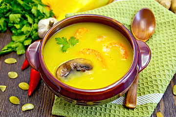 Image showing Soup-puree pumpkin with prawns and mushrooms on green napkin