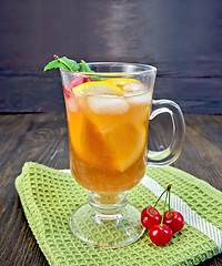 Image showing Lemonade with cherry in wineglass on napkin