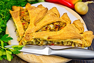 Image showing Pie with cabbage and sorrel on board