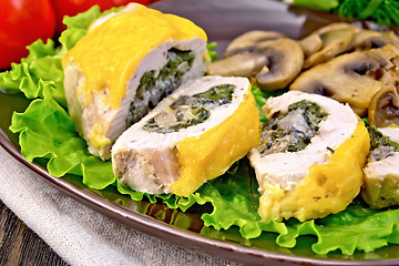 Image showing Roll chicken with champignons on board