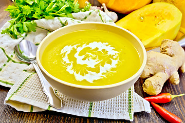 Image showing Soup-puree pumpkin with cream in bowl on napkin and board