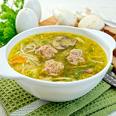 Image showing Soup with meatballs and noodles in bowl on napkin