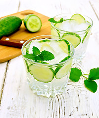 Image showing Lemonade with cucumber and mint in two glassful on light board