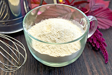 Image showing Flour amaranth in glass cup with sieve on board