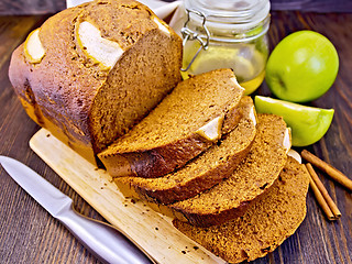 Image showing Bread apple with honey on dark board