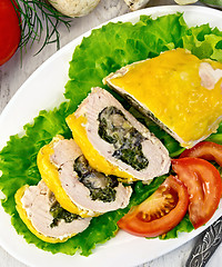 Image showing Roll chicken with spinach and tomatoes on board