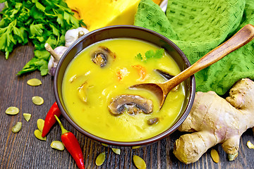 Image showing Soup-puree pumpkin with mushrooms and shrimp on board