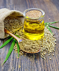 Image showing Flour hemp in spoon with oil and bag on board