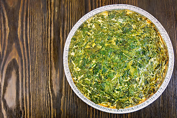 Image showing Pie celtic with spinach in form of foil on table