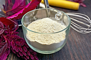 Image showing Flour amaranth in glass cup with rolling pin on board