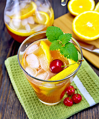 Image showing Lemonade with cherry in glassful and pitcher on board