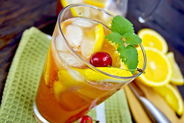 Image showing Lemonade with cherry in glassful on board