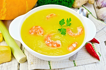 Image showing Soup-puree pumpkin with shrimp in white bowl on napkin