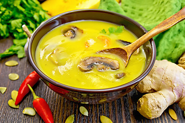 Image showing Soup-puree pumpkin with mushrooms and shrimp on dark board