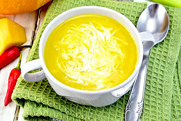 Image showing Soup-puree pumpkin with cream in white bowl on napkin