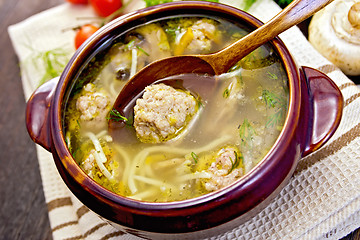 Image showing Soup with meatballs and noodles in pottery on napkin