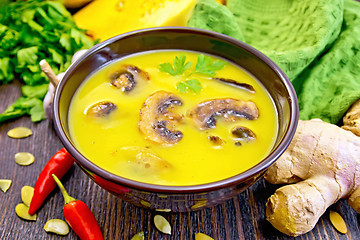 Image showing Soup-puree pumpkin with mushrooms and ginger on board