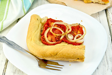 Image showing Pie with onions and tomatoes in white plate on board