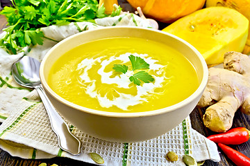 Image showing Soup-puree pumpkin with cream in bowl on napkin