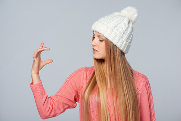Image showing Woman holding imaginary product