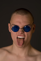 Image showing The bald guy shows tongue