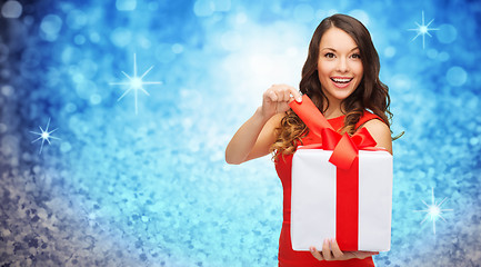 Image showing smiling woman in red dress with gift box