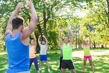 Image showing group of friends or sportsmen exercising outdoors