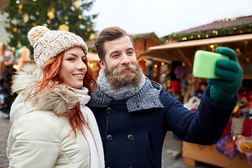 Image showing couple taking selfie with smartphone in old town