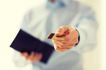 Image showing close up of man holding wallet and credit card