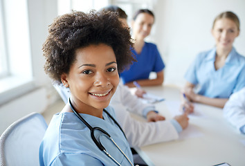 Image showing happy doctor over group of medics at hospital