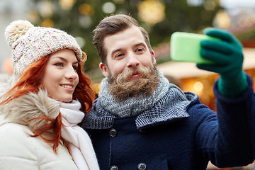 Image showing couple taking selfie with smartphone in old town