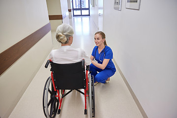 Image showing nurse with senior woman in wheelchair at hospital