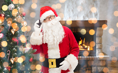 Image showing santa claus with smartphone and christmas tree