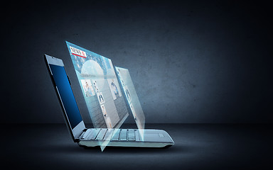 Image showing laptop computer with news web page projection