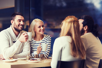 Image showing happy friends meeting and drinking tea or coffee